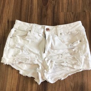 White ripped American eagle shorts